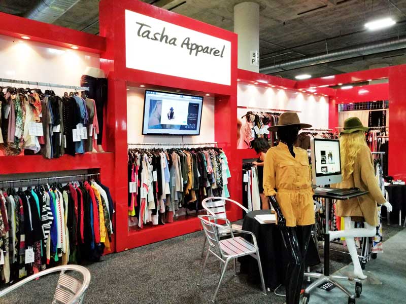 Booth for Tasha Apparel showcasing wholesale clothing at the Las Vegas Offprice Show.