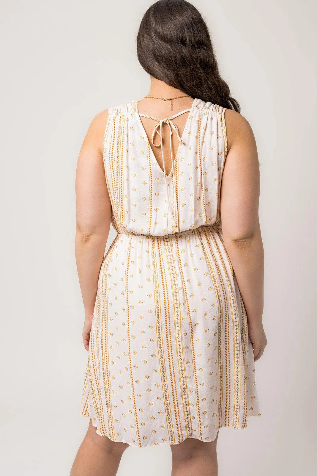 Plus Size Sleeveless Surplice Back Tie Floral Mini Dress - Tasha Apparel Wholesale